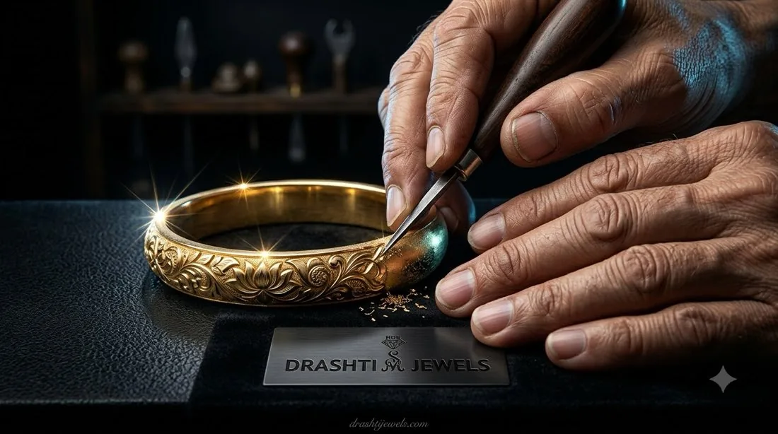 A craftsman hand-engraving a floral pattern into a gold bangle at the bench